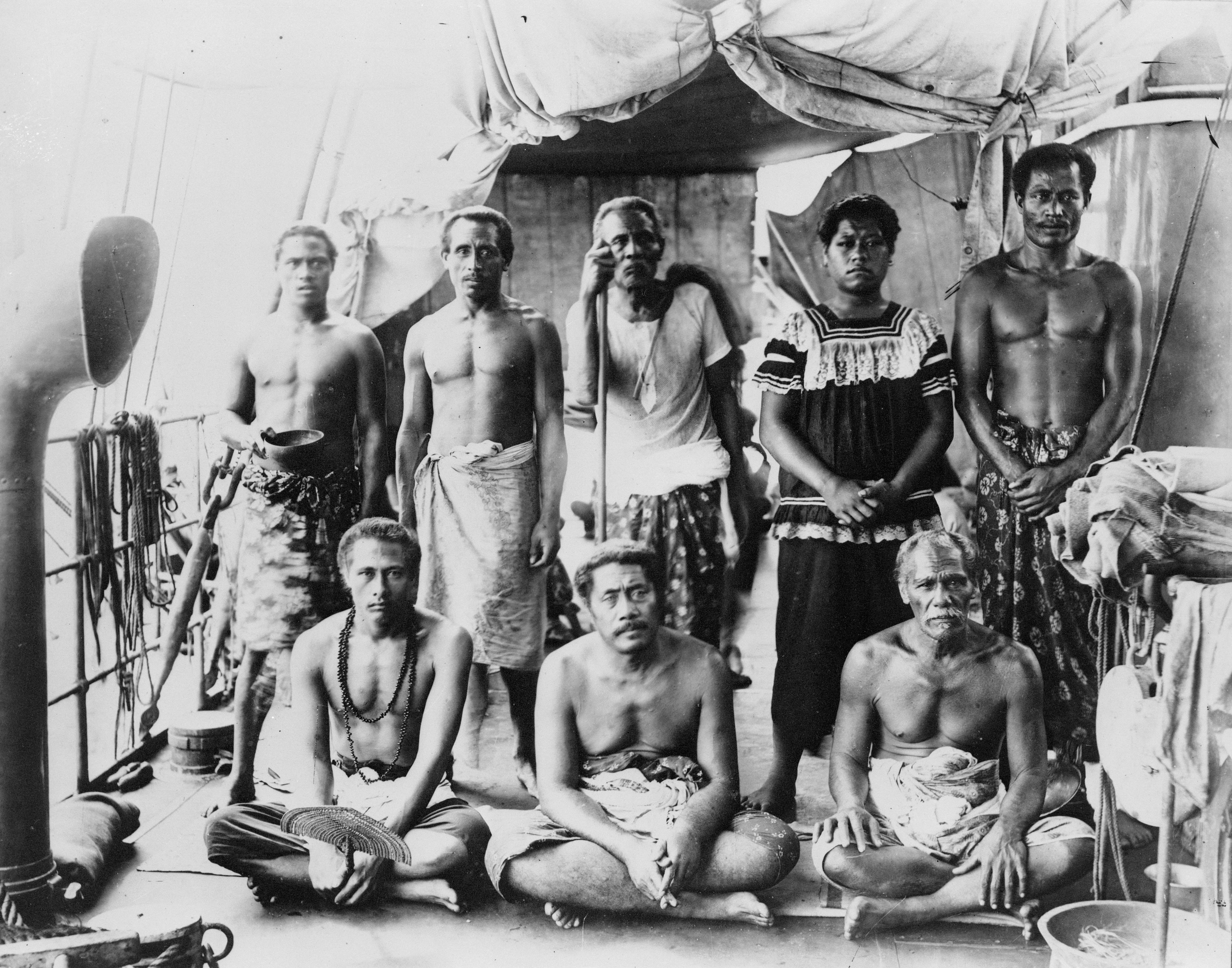 Orator yang diasingkan, Lauaki Namulauʻulu Mamoe (berdiri ketiga dari kiri dengan tongkat orator) dan kepala suku lainnya di atas kapal perang Jerman yang membawa mereka ke pengasingan di Saipan, 1909.