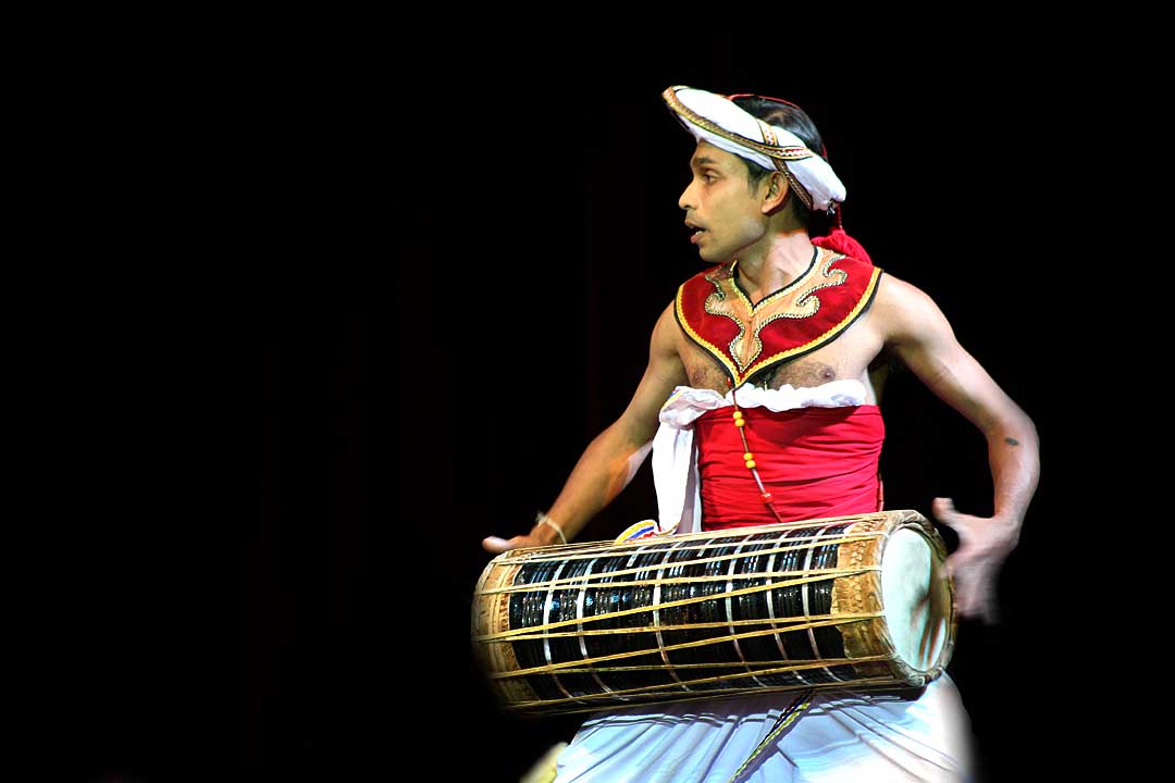 A Low Country drummer playing the traditional Yak Béra, a drum integral to southern Sri Lankan dance forms and rituals, distinct from the Kandyan Geta Béra.