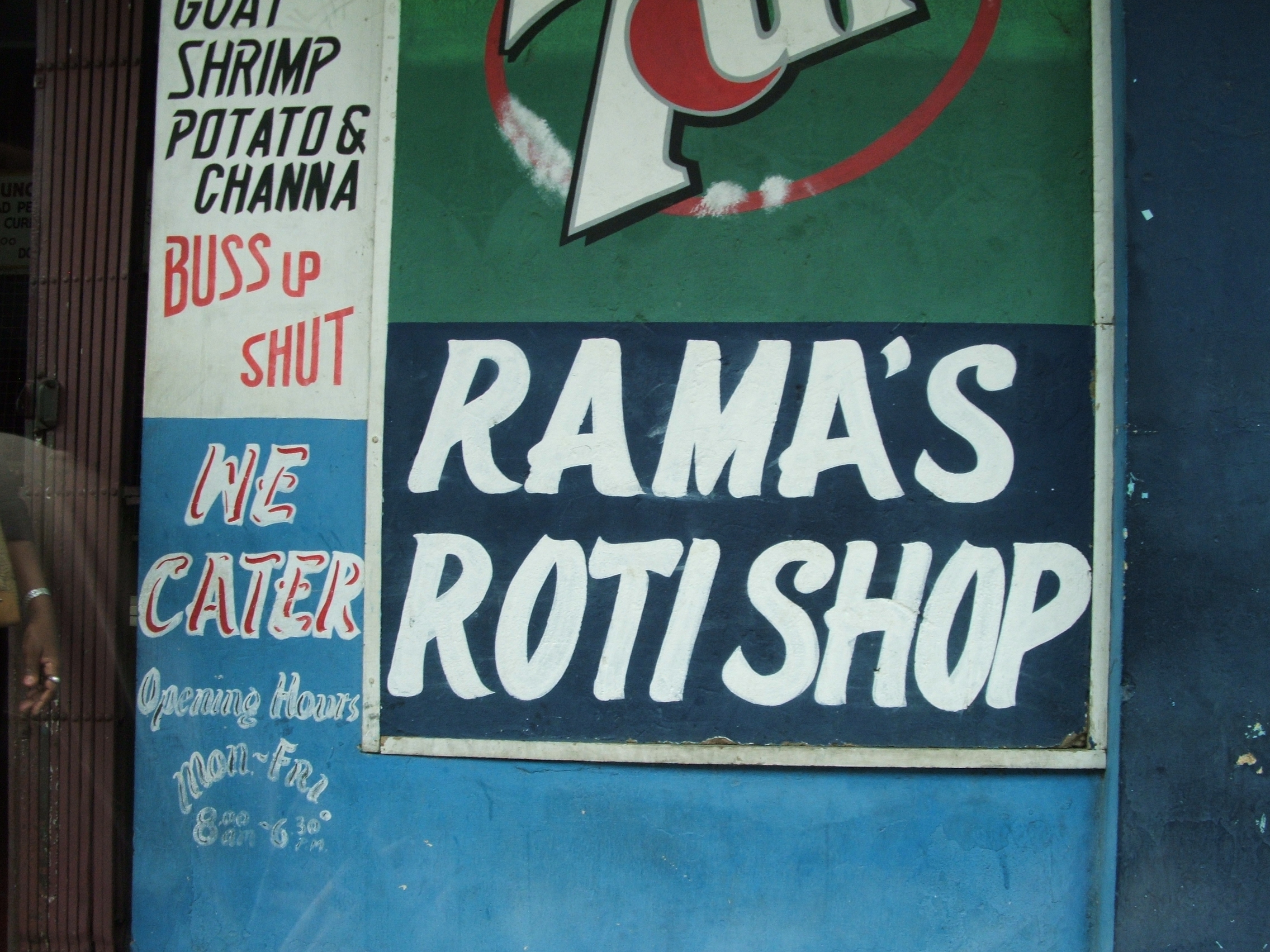 Papan nama toko Roti dalam bahasa Inggris di Port of Spain, buss up shut (paratha) adalah sejenis roti