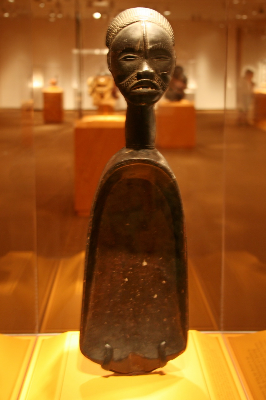 A large wooden ceremonial spoon from Liberia, featuring distinctive carvings.