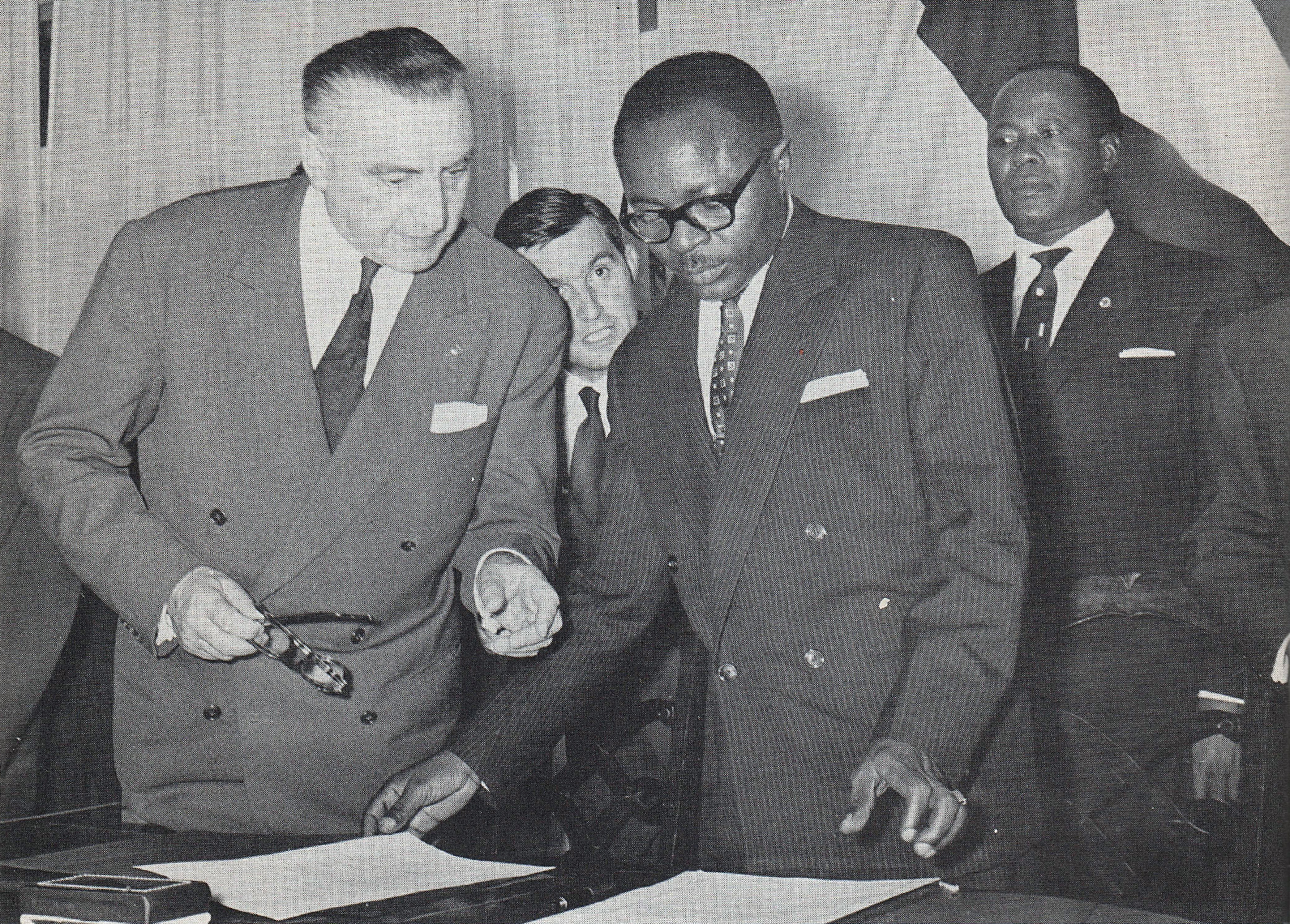 Maurice Yaméogo, the first president of Upper Volta, examines documents pertaining to the ratification of the country's independence in 1960.