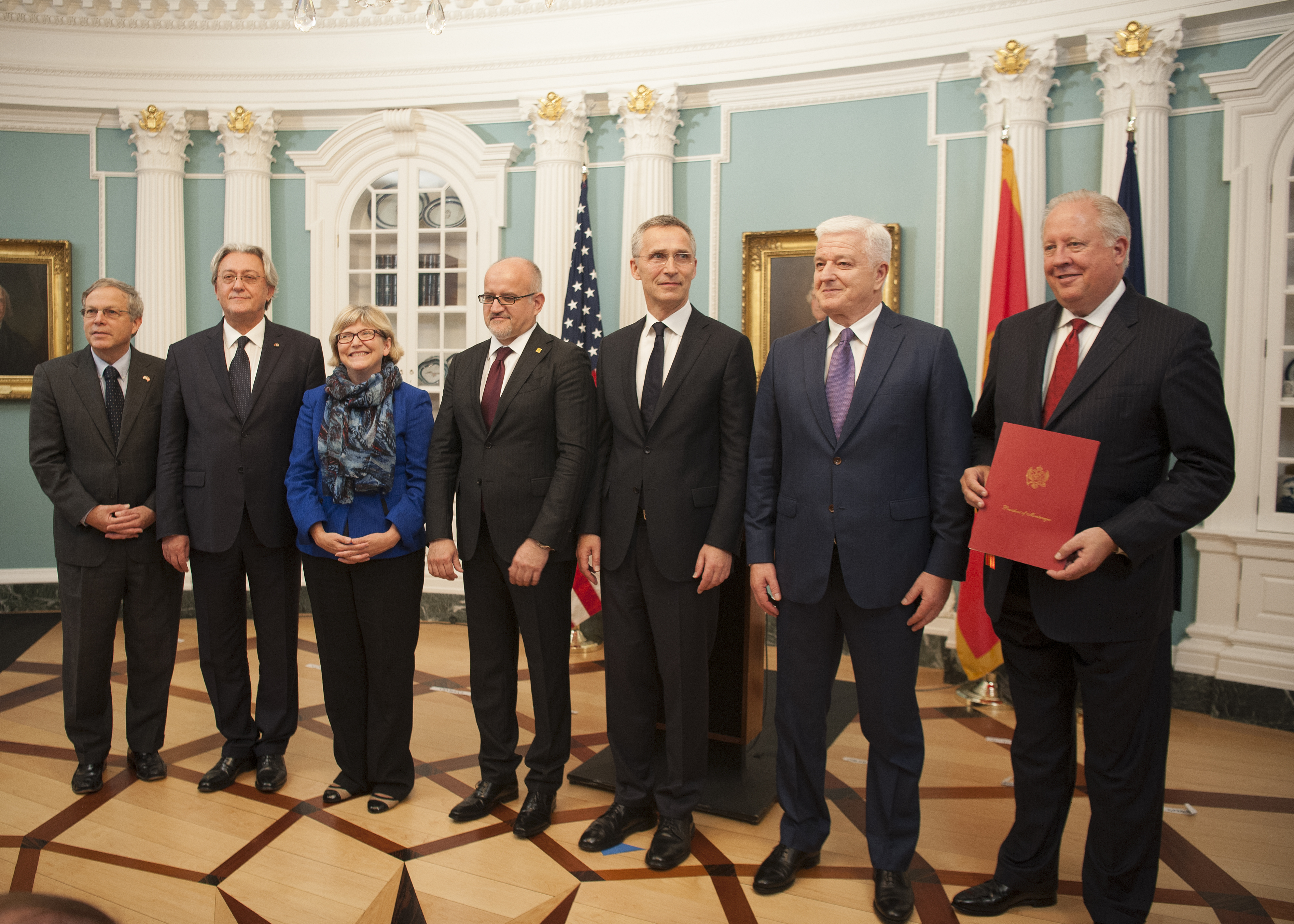 Montenegro Foreign Minister Srdjan Darmanović presents a document to US Undersecretary of State for Political Affairs Thomas A. Shannon Jr. and Montenegro Prime Minister Duško Marković during a ceremony at the State Department to accept Montenegro's instrument of accession to NATO, June 5, 2017.