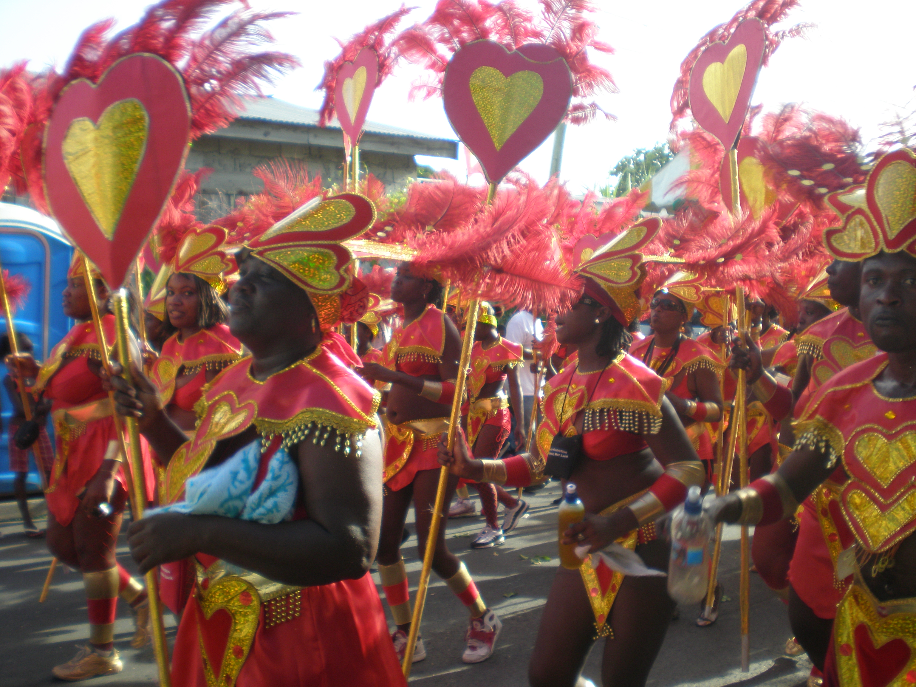 A vibrant street parade during Antigua Carnival, showcasing colorful costumes and energetic music.