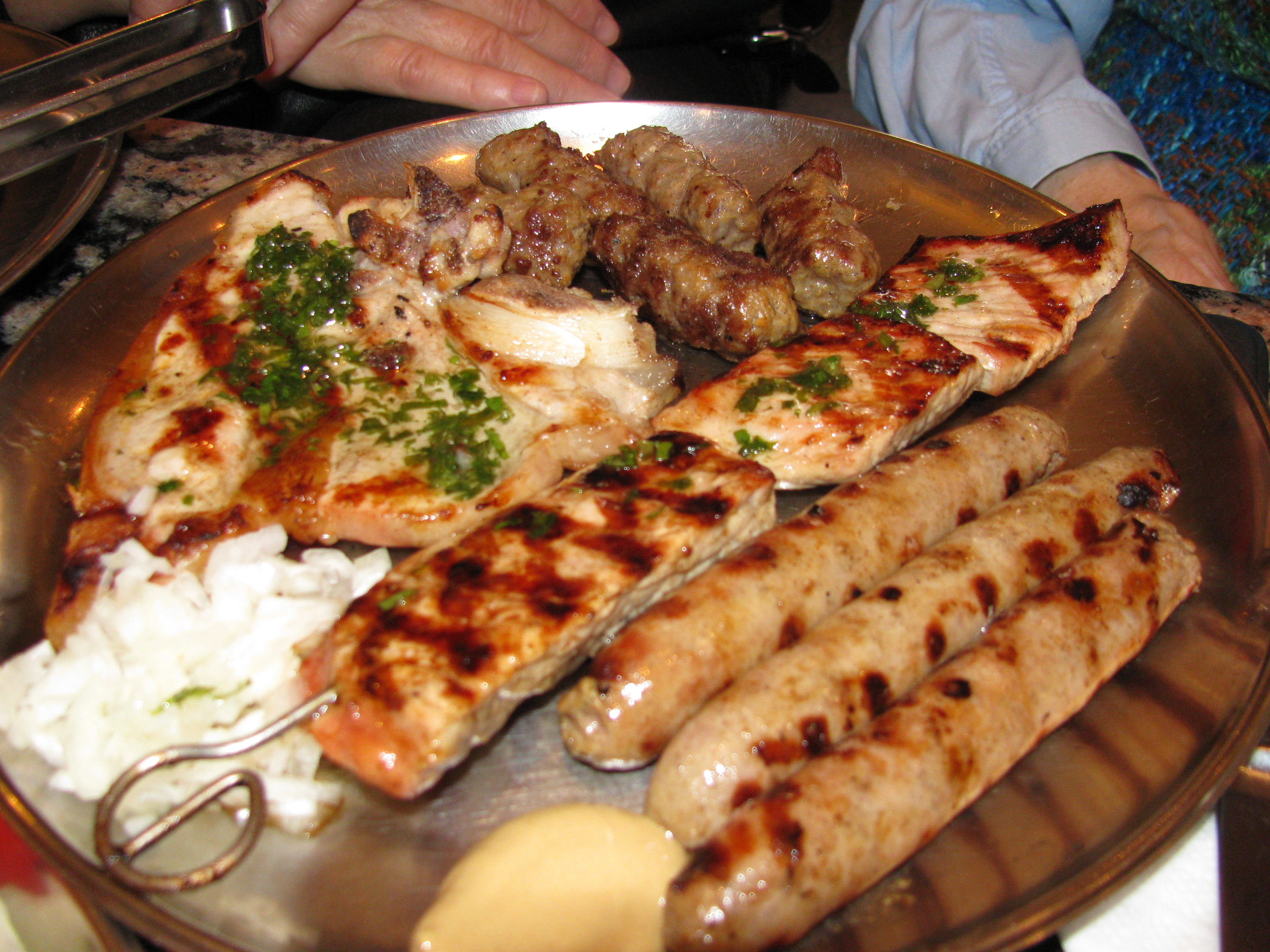 A Bosnian meat platter featuring, among other items, ćevapi, widely considered a national dish of Bosnia and Herzegovina.