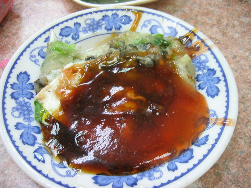 An oyster omelette (蚵仔煎ô-á-chiannan), a highly popular and iconic Taiwanese street food dish, showcasing the island's rich culinary offerings available at night markets and local eateries.