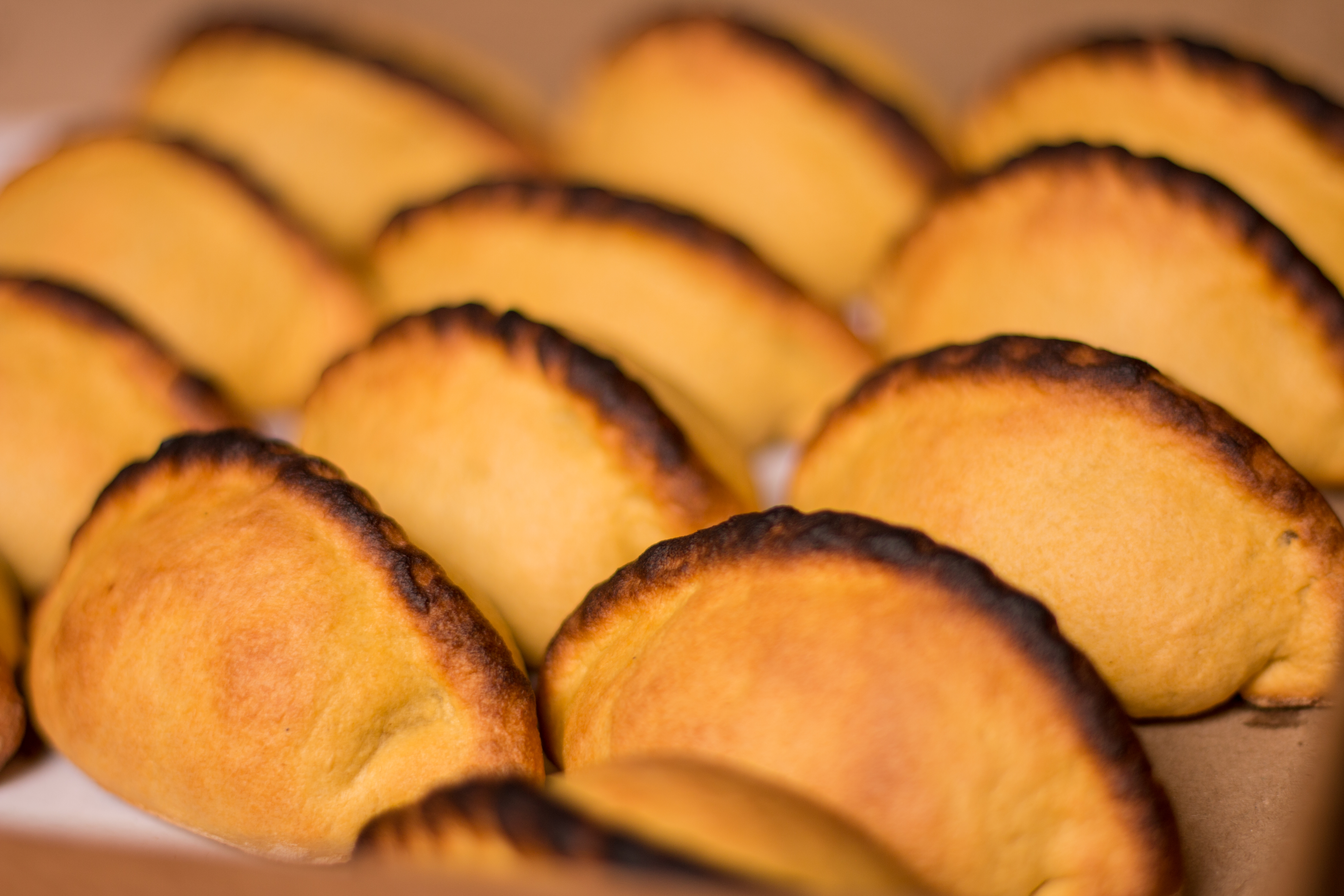 Salteñas, a popular baked empanada in Bolivia, known for their savory and slightly sweet filling.